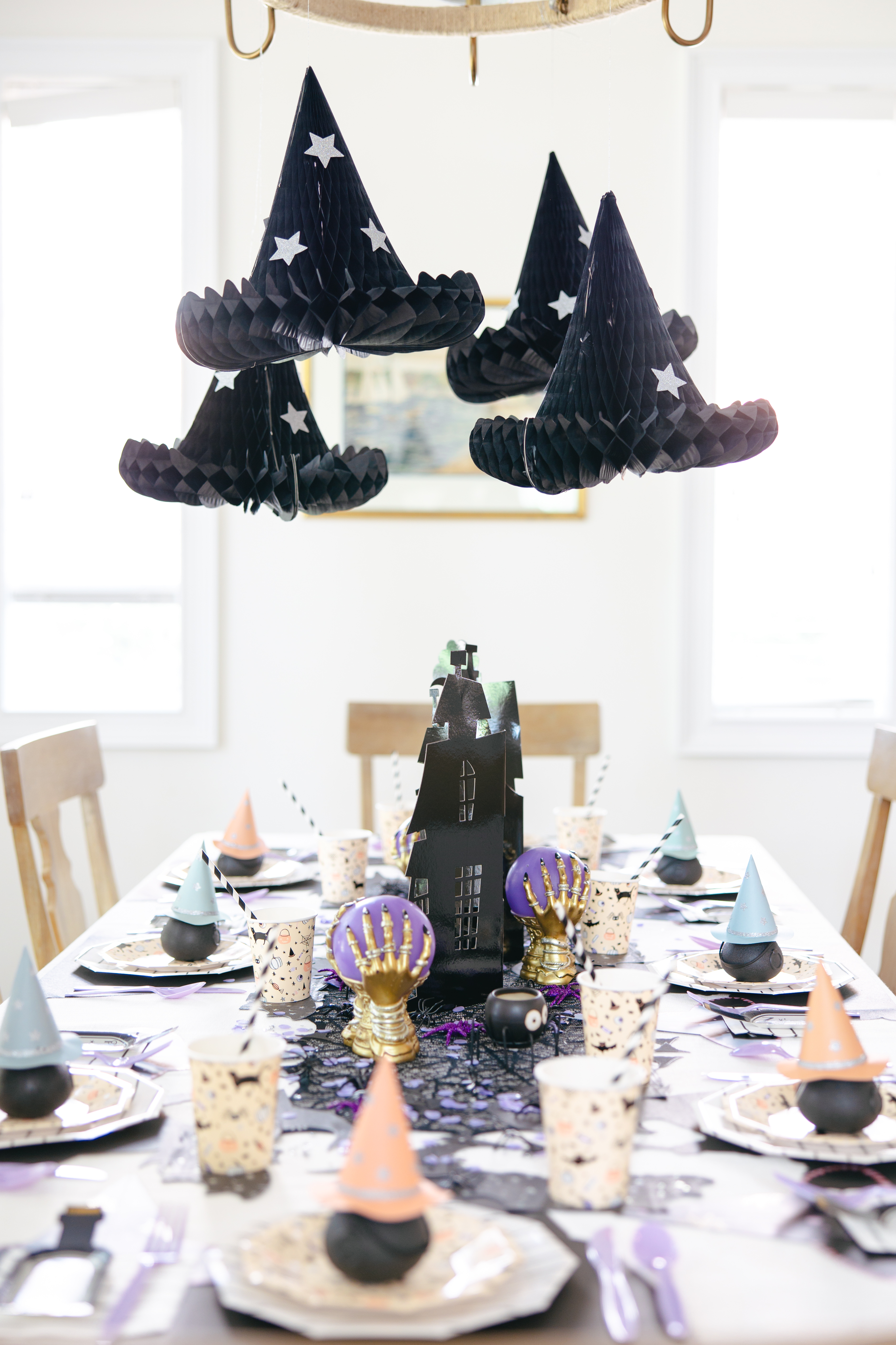 Overview of the witch table with a focus on the Meri Meri honeycomb witch hats.
