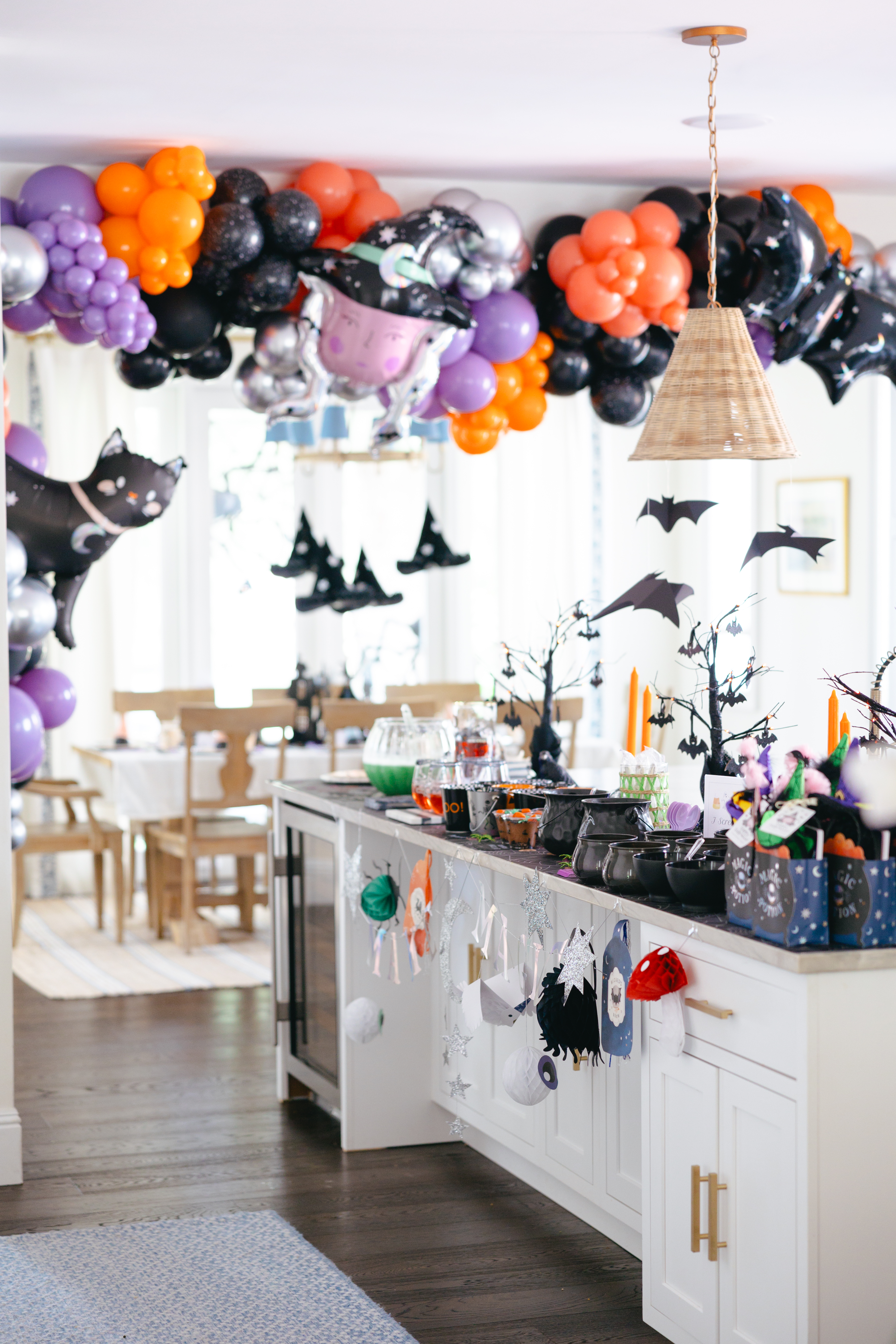 Buffet setup with balloons in black, orange and purple